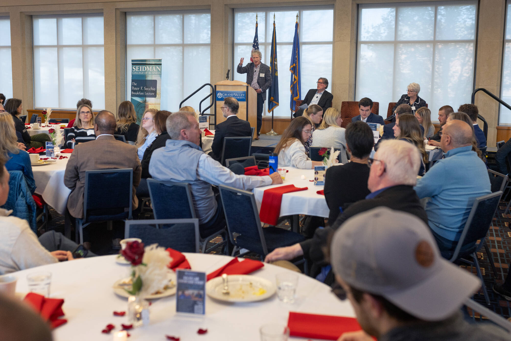Secchia guests listening to the presentation; speaker Michael is behind the podium